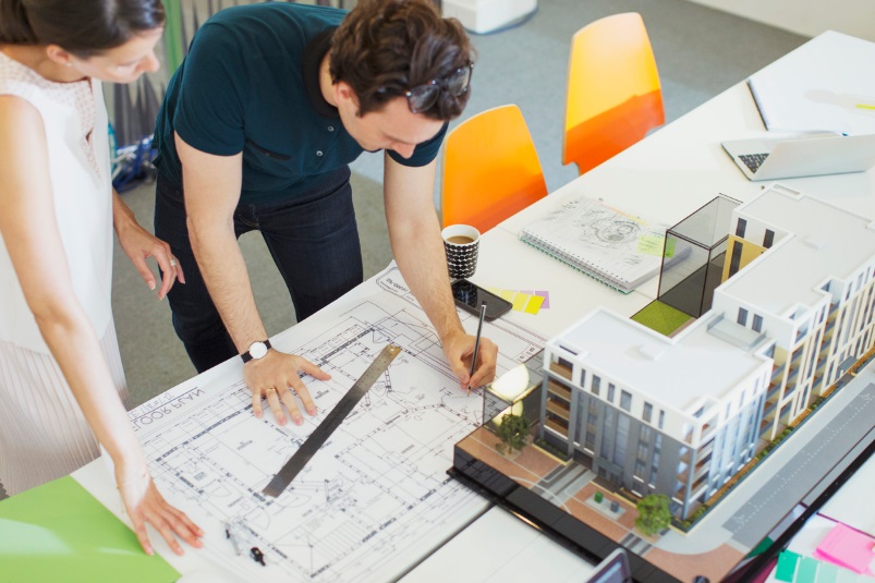 Un homme et une femme devant maquette de bâtiment