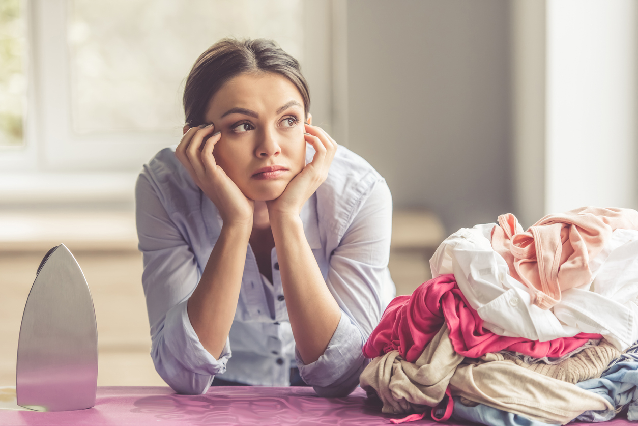 femme fatiguée sur table à repasser