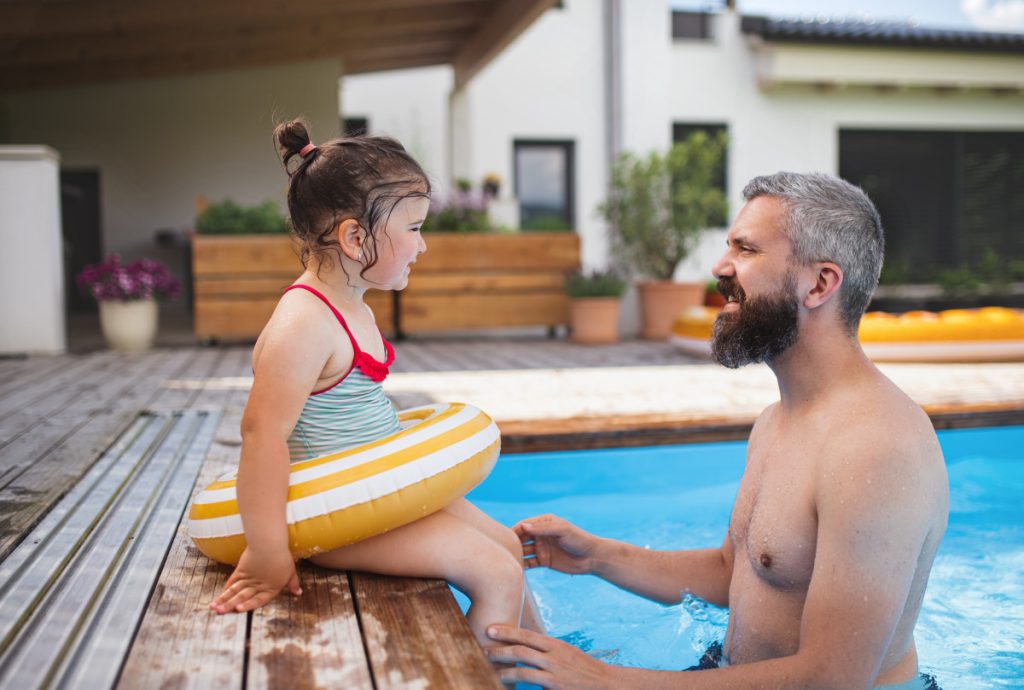 Père avec sa fille dans une piscine
