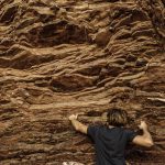 rock-climber-reaching-for-his-next-hand-hold-2023-11-27-05-27-18-utc